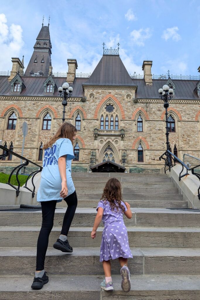 kids running up the stairs to the West Block building on Parliament Hill
