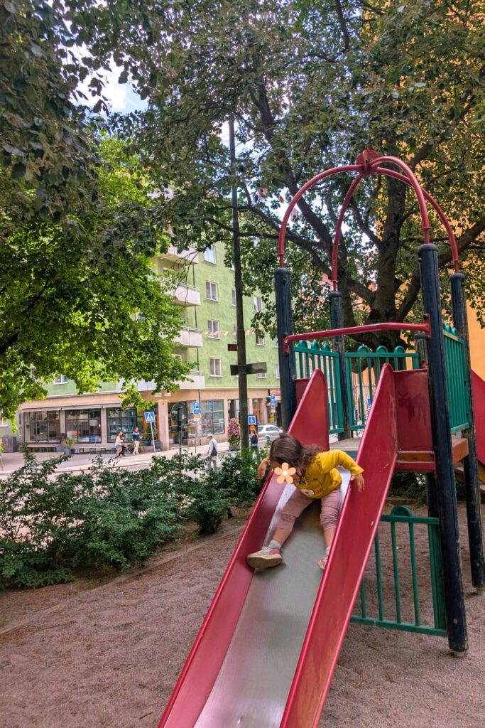 my daughter going down a slide in a playground in Stockholm