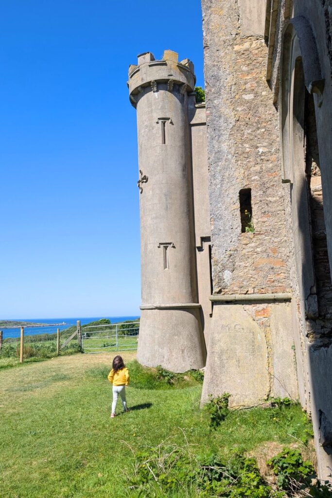 A toddler walking in front of Clifden Castle