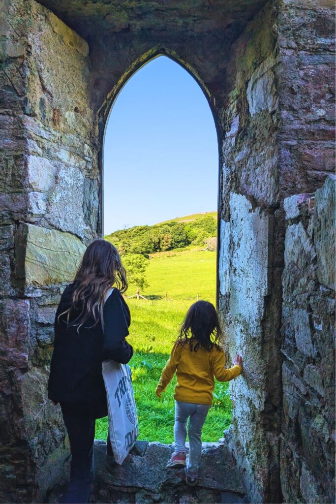my daughters and I looking out one of the windows of Clifden Castle