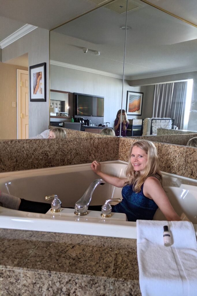 a woman sitting in an in-room jacuzzi at the Nottawasaga Inn 
