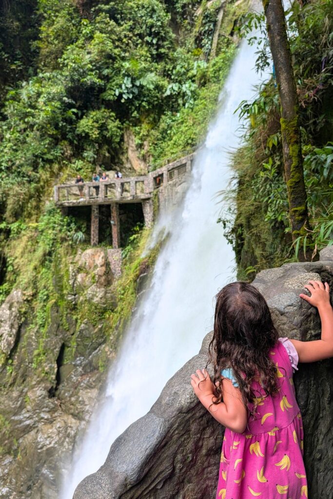 Little girl looking at the El Pailon de Diable in Baños, Ecuador