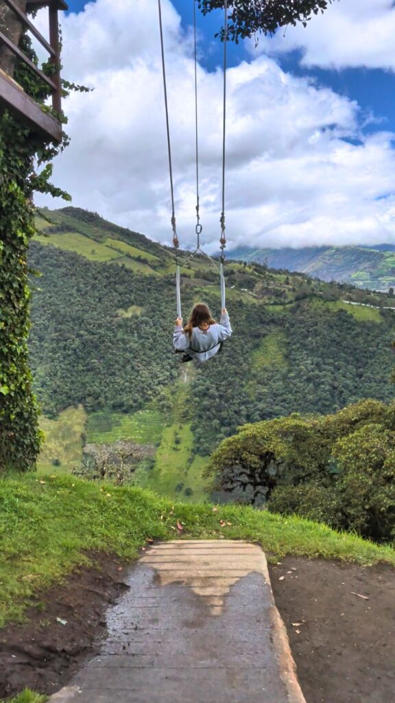 swinging at the end of the clouds in Baños, Ecuador