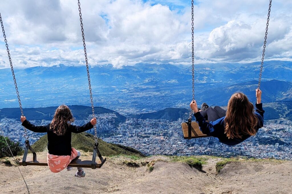 girls swinging at the top of Pichincha in Quito